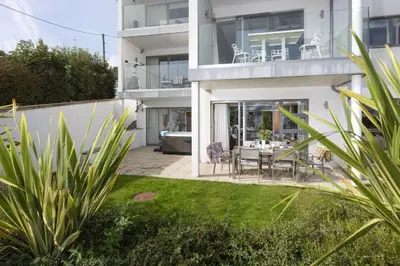 a house with a patio with a table and chairs at Rockpool at Salt in St Ives