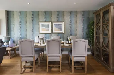 a dining room with a table and four chairs at Rockpool at Salt in St Ives