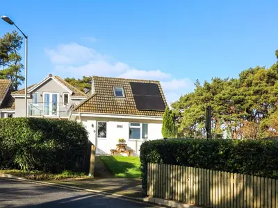 a house with a solar panel on the roof at The Lodge in Carlyon Bay
