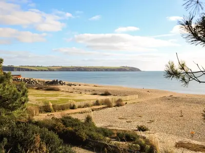 a view of a beach with the ocean in the background at The Lodge in Carlyon Bay