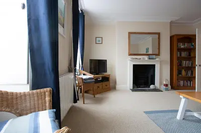 a living room with a television and a fireplace at Elegant 2 bed in the heart of Falmouth - sleeps 4 in Falmouth