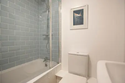 a bathroom with a toilet and a tub and a sink at Elegant 2 bed in the heart of Falmouth - sleeps 4 in Falmouth