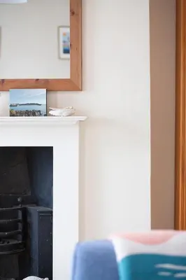 a living room with a fireplace and a bed at Elegant 2 bed in the heart of Falmouth - sleeps 4 in Falmouth