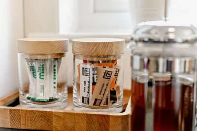 two glass jars of honey on a wooden shelf at 2 Bed in St. Ives oc-92928 in Carbis Bay