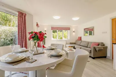a living room with a white dining room table and chairs at 2 Bed in St. Ives oc-92928 in Carbis Bay