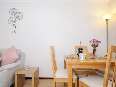 a living room with a table and a couch at St Albans in Boscastle