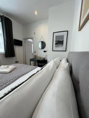 a white bedroom with a bed and a desk at Private Double Room with Ensuite, No Breakfast, Truro City Centre in Truro