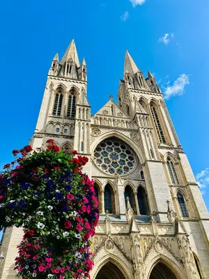 a church with two towers with flowers in front at Private Double Room with Ensuite, No Breakfast, Truro City Centre in Truro
