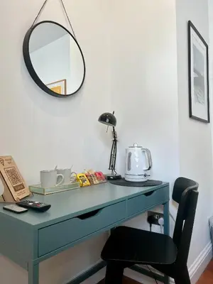 a blue desk with a mirror and a chair at Private Double Room with Ensuite, No Breakfast, Truro City Centre in Truro
