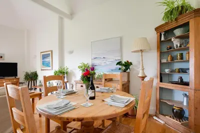 a dining room with a wooden table and chairs at 2 Bed in Wadebridge oc-p00374 in Wadebridge
