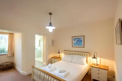 a bedroom with a bed with two towels on it at Chymoresk - Self Catering Holiday Cottage Hayle St Ives Bay in Hayle