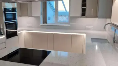 a kitchen with white cabinets and a large window at Chymoresk - Self Catering Holiday Cottage Hayle St Ives Bay in Hayle