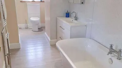 a bathroom with a tub and a toilet and a sink at Chymoresk - Self Catering Holiday Cottage Hayle St Ives Bay in Hayle
