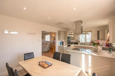 a kitchen and dining room with a table and chairs at Chymoresk - Self Catering Holiday Cottage Hayle St Ives Bay in Hayle