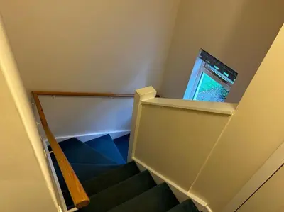 a staircase with a window and a stair case at Creek Cottage in Budock Water