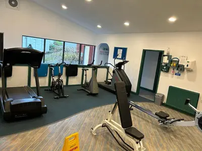 a gym with several exercise bikes and tread machines at Creek Cottage in Budock Water
