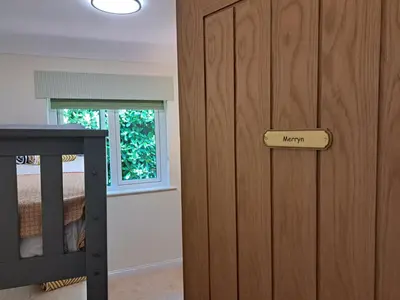 a wooden door with a happy sign on it in a bedroom at Trevallion in Saint Endellion