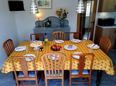 a dining room table with a yellow polka dot table cloth at Trevallion in Saint Endellion