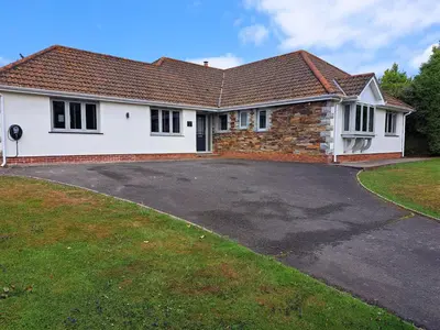 a house with a driveway in front of it at Trevallion in Saint Endellion