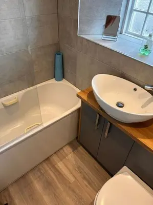 a bathroom with a sink and a tub and a toilet at Waves Cottage, Newquay. in Newquay