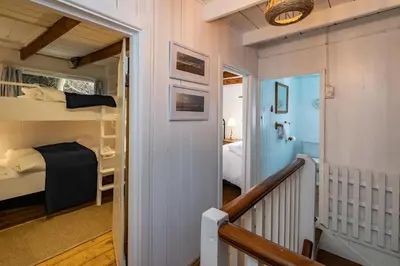 a small room with a bunk bed and a staircase at Sea Horses in Port Isaac