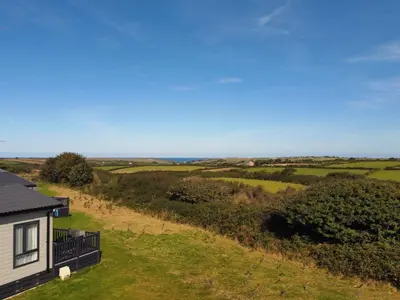an aerial view of a house and the ocean at Holywell Lodge in Newquay