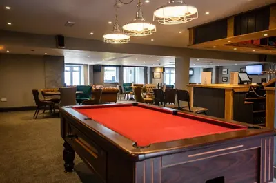 a pool table in a room with a bar at Holywell Lodge in Newquay