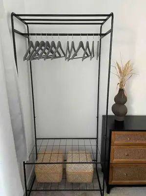 a shelf with two baskets and a vase on a table at Peaceful centrally located, 2 Bedroom Bungalow. in Camborne