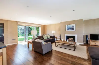 a living room with a couch and a fireplace at Moonfleet in Saint Mawes