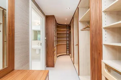 a walk in closet with a toilet and a sink at Moonfleet in Saint Mawes