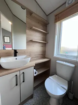 a bathroom with a white toilet and a sink at Holywell View 30 in Cubert