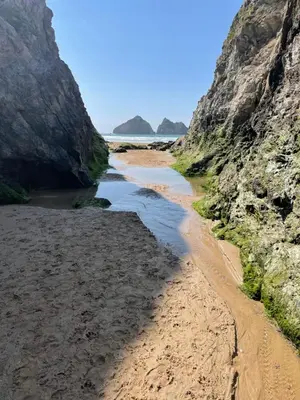 a view of a beach between two cliffs at Holywell View 30 in Cubert