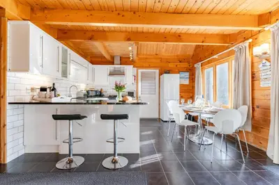 a kitchen and dining room with a table and chairs at Hillview in Little Petherick