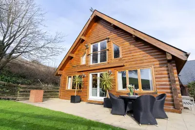 a cabin with a table and chairs in front of it at Hillview in Little Petherick