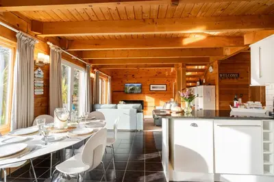 a kitchen and living room with a table and chairs at Hillview in Little Petherick