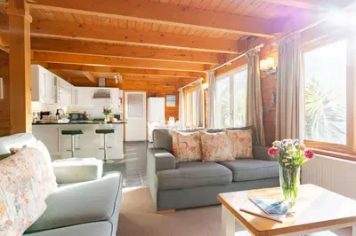 a living room with a couch and a table at Hillview in Little Petherick