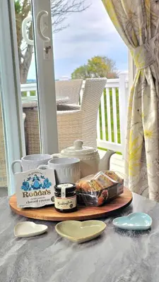 a table with a tray of food on a porch at Perranporth HOT TUB 3 Bed Dog friendly Home in Newquay