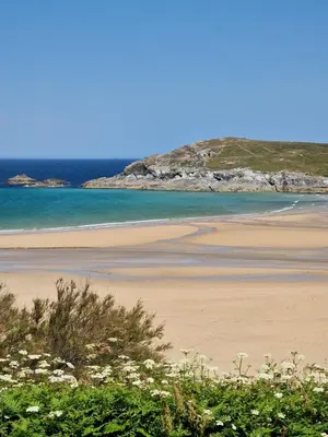 a sandy beach with the ocean in the background at Perranporth HOT TUB 3 Bed Dog friendly Home in Newquay