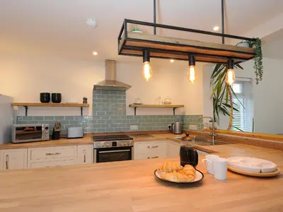 a kitchen with a table with a plate of food on it at Gwennel Neyth in Newquay