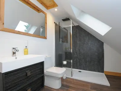 a bathroom with a toilet and a sink and a shower at Gwennel Neyth in Newquay