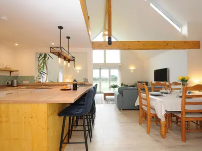 a kitchen and dining room with a table and chairs at Gwennel Neyth in Newquay
