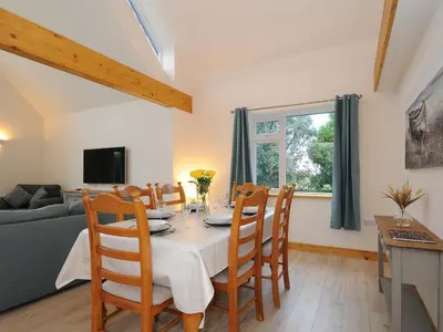 a dining room with a table and chairs at Gwennel Neyth in Newquay