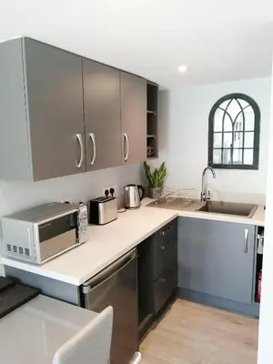 a kitchen with a counter top with a microwave at Valkyrie in Perranzabuloe