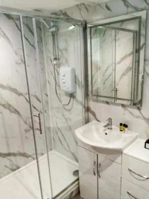 a bathroom with a shower and a sink at Valkyrie in Perranzabuloe