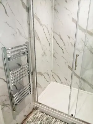 a bathroom with a shower with a glass door at Valkyrie in Perranzabuloe