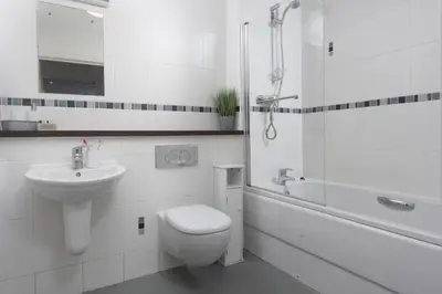 a bathroom with a toilet and a sink and a shower at Bathsheba, Ocean 1 in Newquay