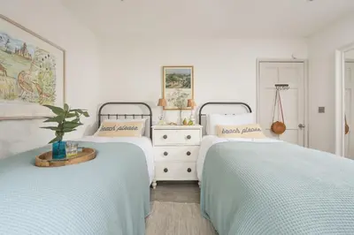 two beds sitting next to each other in a bedroom at Rosehendra in Saint Erth