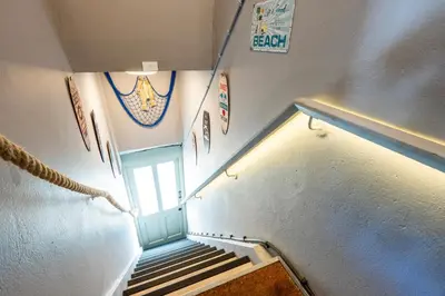an overhead view of a stairway with a blue door at Beachspoke Loft in Redruth