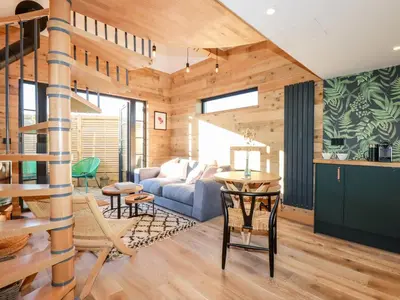 a living room with a couch and a table at Little Beach Cabin in Newquay