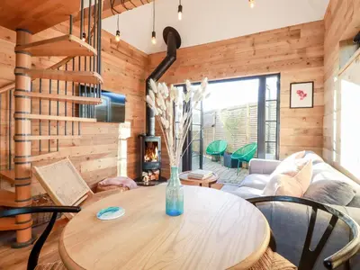 a living room with a table and a couch at Little Beach Cabin in Newquay